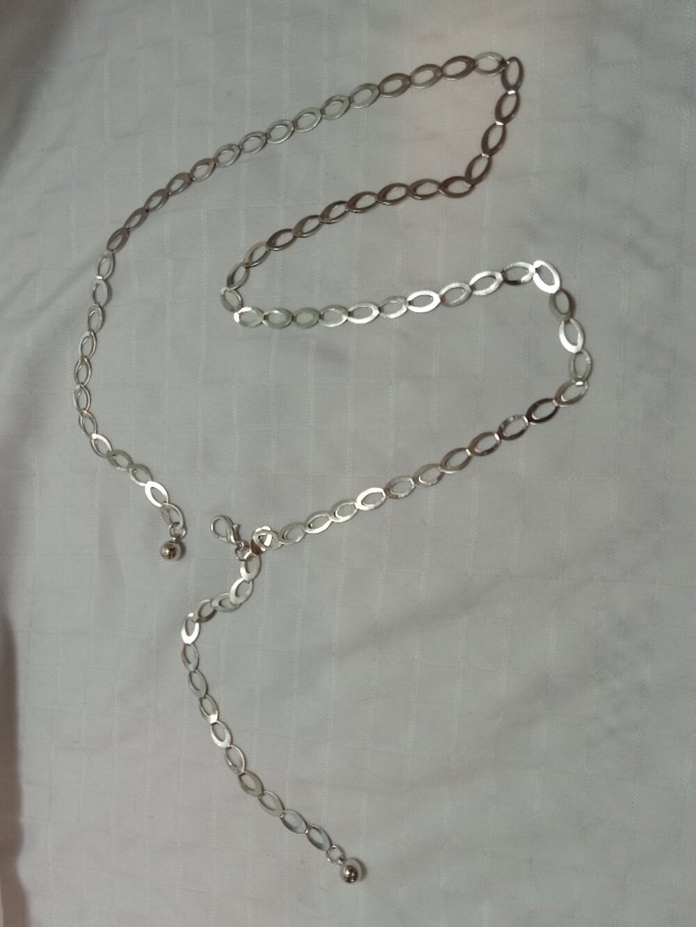 A pretty silver-colored belt with a thin, large-link chain 36 inches